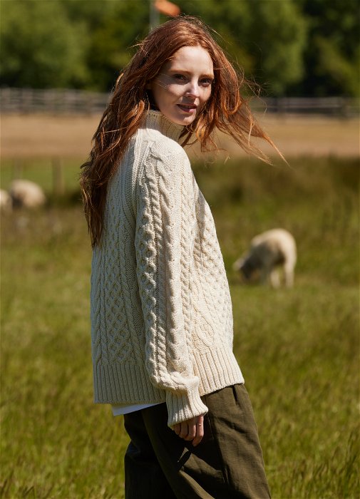 Image of model wearing Sophie Cable Jumper. Model is 5ft8, size UK 8 and wearing size Small
