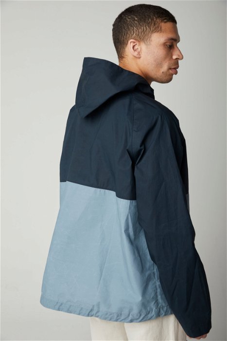 Image of model wearing Alpine Cagoule. Model is 6ft, chest size 36in and wearing size Large