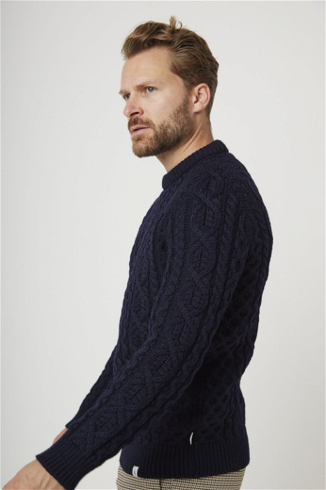 Image of model wearing Hudson Aran Jumper. Model is 6ft1in, chest size 38in and wearing size Medium