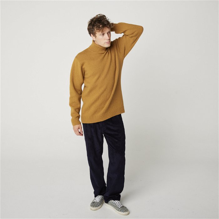 Image of model wearing Makers Stitch Polo Neck. Model is 6ft1in, chest size 38in and wearing size Large