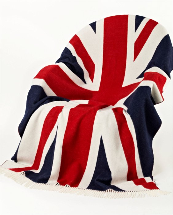 Image of model wearing Union Jack Wool Blanket. Size: 200cm x 135cm (includes fringe)