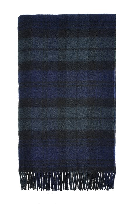 Image of model wearing Wool Blanket. SIZE: 180CM X 140CM (INCLUDES FRINGE)