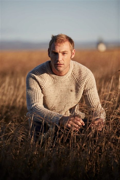 Image of model wearing Waffle Crew Neck Jumper. Model is 6ft1in, chest size 38in and wearing size Medium